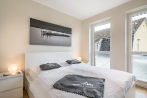 Postel nebo postele na pokoji v ubytování Südhafen 1 OG - Whg 3
