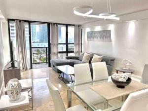 a living room with a table and a couch at 2BD Close to views Sky-Rise 14 in Miami