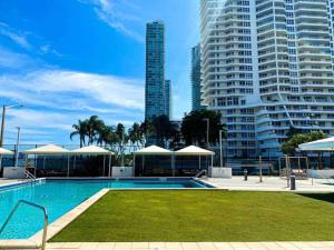 a swimming pool in a city with tall buildings at 2BD Close to views Sky-Rise 14 in Miami