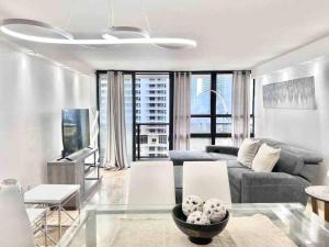 a living room with a couch and a tv at 2BD Close to views Sky-Rise 14 in Miami