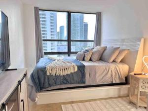 a bedroom with a bed with a large window at 2BD Close to views Sky-Rise 14 in Miami