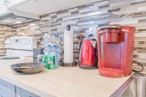 a kitchen counter with a red appliance on it at Executive Apartment - 2BDR Parking Self-check in - Walkout basement Lower Unit in Mississauga