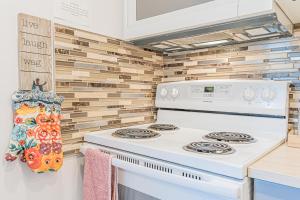 a white stove in a kitchen with wooden walls at Executive Apartment - 2BDR Parking Self-check in - Walkout basement Lower Unit in Mississauga