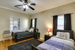 a bedroom with two beds and a ceiling fan at Spacious Albany Retreat Near Flint River Trail! in Albany