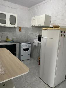 una cucina con frigorifero bianco e piano cottura di Casa Tina a Jaguaribe