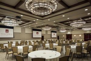 a conference room with tables and chairs and chandeliers at The Alfond Inn in Orlando