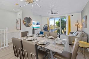 a dining room and living room with a table and chairs at 8036 Cool Breeze Drive 133 in Orlando