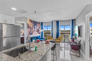 a kitchen with a counter and a living room at 6165 Carrier Drive 3805 in Orlando