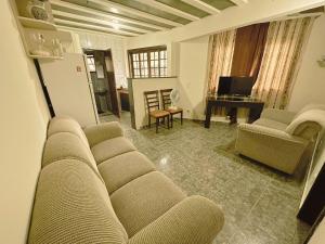a living room with a couch and a table at Condomínio Fazenda Garatucaia in Angra dos Reis