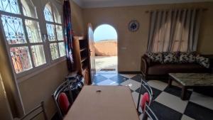 a living room with a table and a couch at Riad Al Afrah in Id Chahadene +5 photos