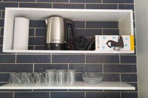 a shelf with glasses and a coffee maker on it at Cabana Linha Brasil in Nova Petrópolis