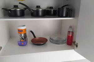 a kitchen with two pots and pans on a shelf at Cabana Linha Brasil in Nova Petrópolis +26 photos