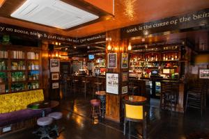 a bar with many bar stools in a room at The Hyde - At Dunning's Bar in Watford