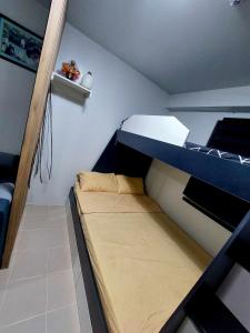 a small room with a bunk bed in it at Plumera Homes in Lapu Lapu City