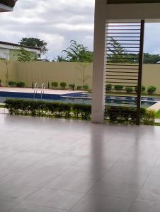 a building with a pool and two faucets at Plumera Homes in Lapu Lapu City