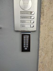 a pay phone is attached to a wall at Penedo Grande suítes T2 in São Bartolomeu de Messines