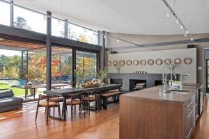 a kitchen with a table and chairs and a fireplace at Magical Country Retreat in the Berkshires in Great Barrington