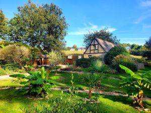 a garden in front of a house at Le Vieux Moulin Gites - Detached cottage with garden views and pool in Guégon
