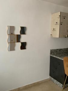 a white wall with a chair and boxes on it at Appartement propre et calme in Casablanca