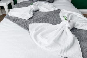 a white robe on top of a bed at City Gate Guest House in London