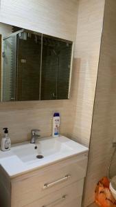 a bathroom with a sink and a mirror at Appartement propre et calme in Casablanca