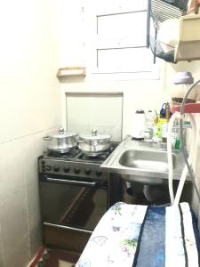 a small kitchen with a stove and a sink at Furnished apartment in Minya in Minya