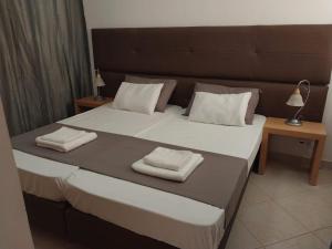 a bedroom with a large bed with two towels on it at Solaren Apartments Boavista in Sal Rei