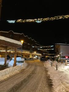 a dirt road with snow on it at night at 1650 Moriond - 2 Double Bedroom near Snow Front in Courchevel