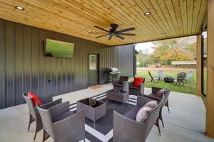a patio with a table and chairs and a ceiling at Chic Arkansas Retreat with Patio, Grill and Fire Pit! in Fairfield Bay