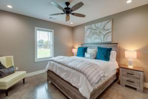 a bedroom with a bed and a ceiling fan at Chic Arkansas Retreat with Patio, Grill and Fire Pit! in Fairfield Bay