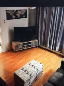 a living room with a couch and a television at Le 10620 beau, grand et charmant 5 et demi in Quebec City