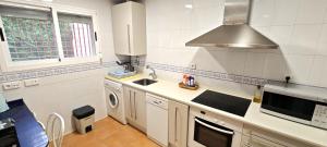 a kitchen with a sink and a stove at Vistas Río Tormes Huerta Otea in Salamanca