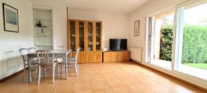 a dining room with a table and chairs and a window at Vistas Río Tormes Huerta Otea in Salamanca