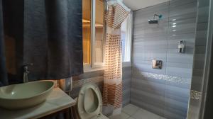 a bathroom with a sink and a toilet at Smart Inn in San Pedro Sula