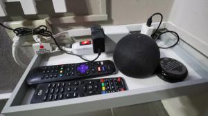 a desk with a keyboard and a remote control at Smart Inn in San Pedro Sula