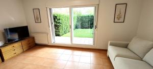 a living room with a couch and a television at Vistas Río Tormes Huerta Otea in Salamanca +21 photos