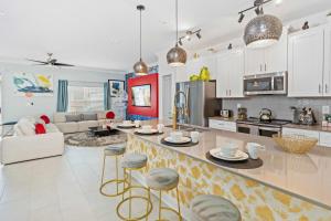 a kitchen and living room with a counter with stools at 2452 Reading Trail in Kissimmee