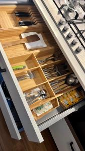 a drawer in a kitchen with lots of utensils at white home near Linate in Segrate