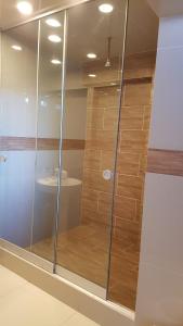 a shower with glass doors in a room at La Cabaña Hotel in Cusco