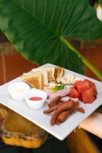 a white plate of food with lobsternets and other foods at Hotel Villabosque Eco Boutique in Manuel Antonio