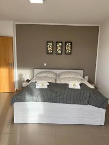 a bedroom with a large bed with two pillows at Sunset Apartment mit Rheinblick in Urbar in Urbar-Mayen-Koblenz