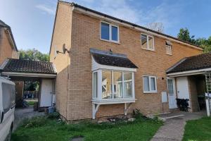 a brick house with a large window at Cosy 2 double bed property in Milton in Milton