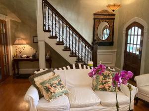 a living room with a white couch with flowers on it at The Villa Toscana in Chicago