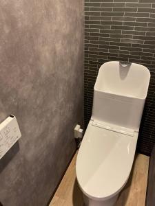 a bathroom with a white toilet in a room at InnCocoSumu？ - Vacation STAY 02654v in Kirishima
