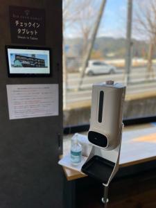 a pay phone on a stand in front of a window at InnCocoSumu？ - Vacation STAY 02654v in Kirishima