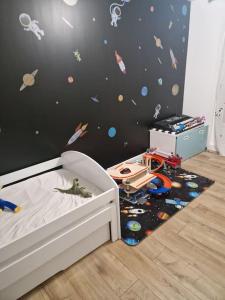 a childs room with a bed with a astronomy wall at Appartement/Apartment/전원주택 15mn from Paris RER C in Viry-Châtillon