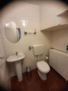 a bathroom with a toilet and a sink and a mirror at Free Spirit in Vale do Torno