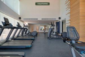 a gym with treadmills and elliptical machines at Cozy Studio with Private Balcony - Pool - Gym in Bucerías
