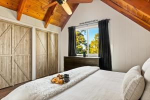 a bedroom with a bed with a tray of fruit on it at Quiet Tri-Level Chalet w/Breathtaking Views in Lake Arrowhead