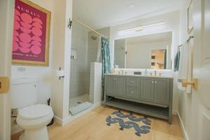 a bathroom with a toilet and a shower and a sink at Bohemian Chic an Eclectic Escape-Hot Tub-Pet Friendly-No Pet Fees! in Albuquerque